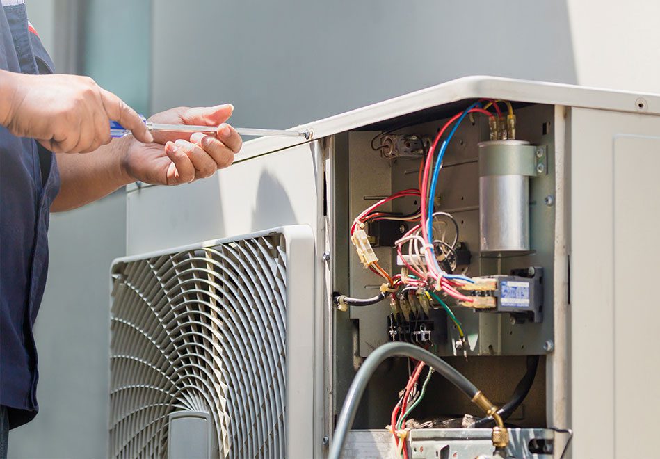 technician hands using a screwdriver fixing modern air conditioner, repairing and servicing, Maintenance and repairing 