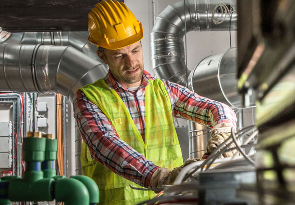 Portrait of a worker, constructing and checking development of a small business hall.